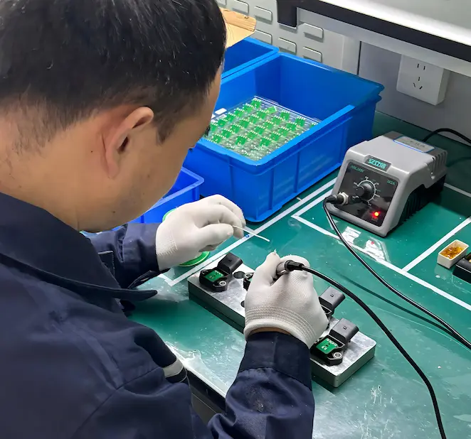 A technician inspecting an automotive sensor housing